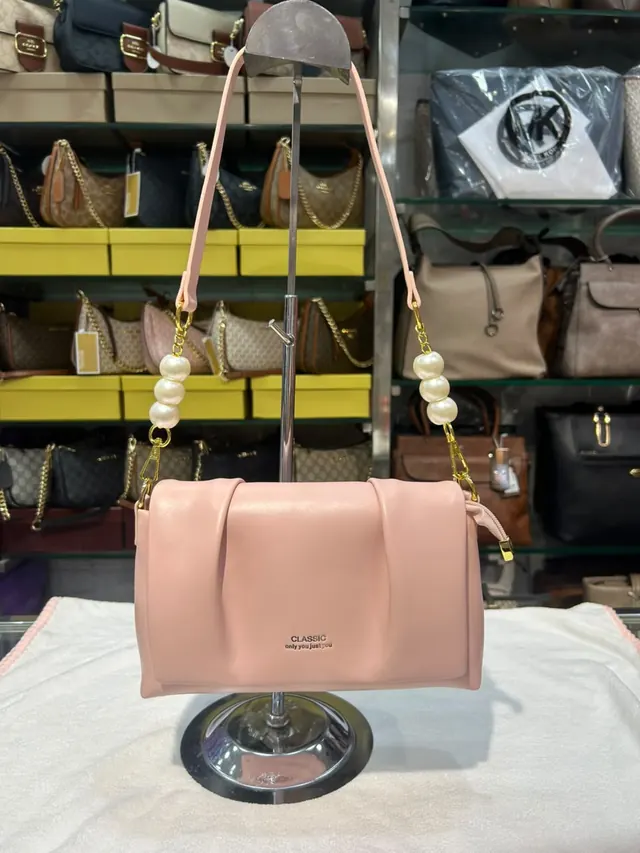 The Pearl-Strap Shoulder Bag in pink, photographed at the Shingar House counter